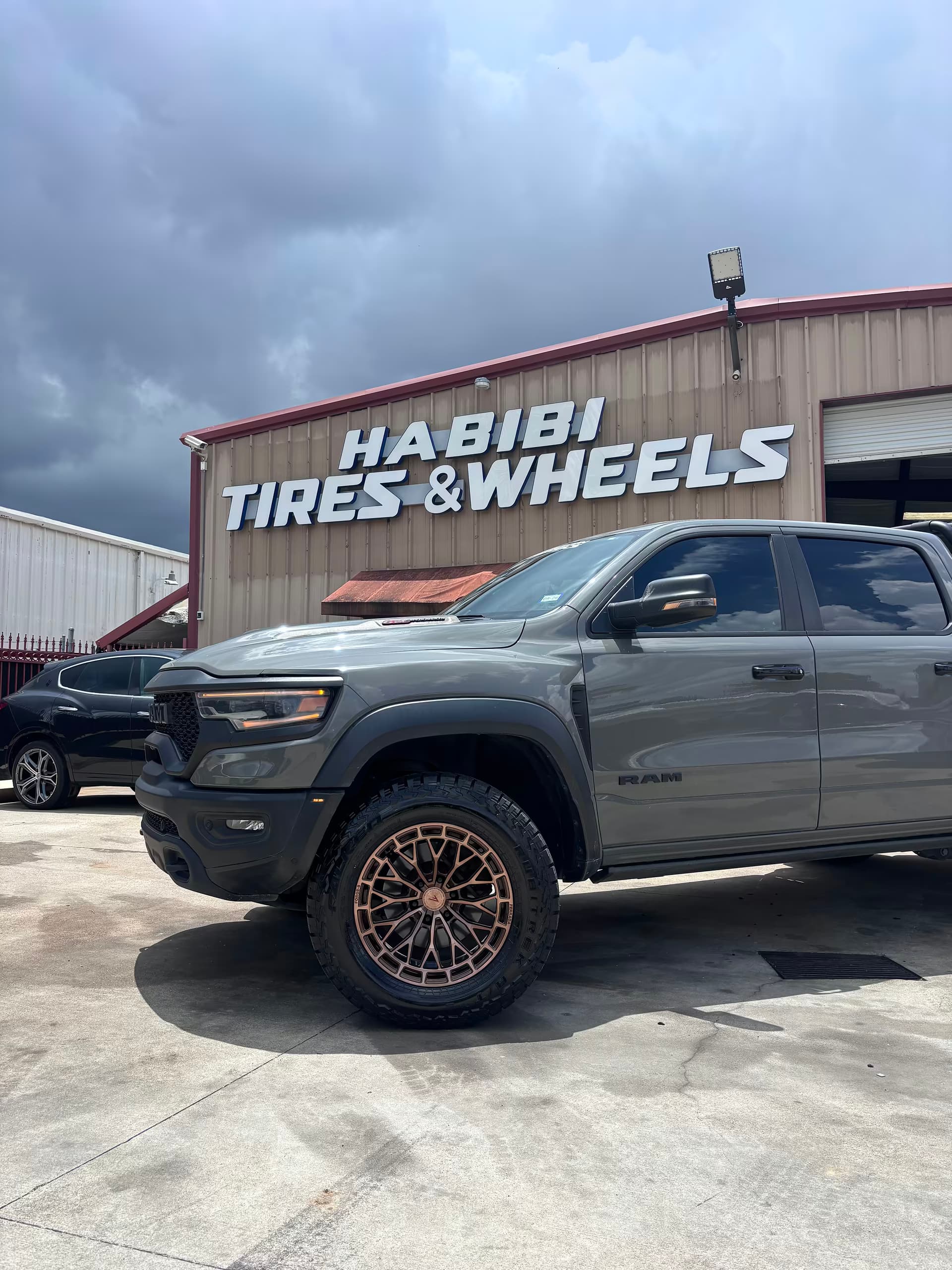 Completed RAM truck outside Habibi Tires and Wheels with its new bronze wheels